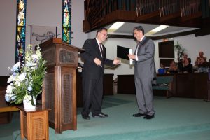 Associate pastor, Dr. Marconi Monteiro, presents a certificate of appreciation to Dr. Alfonso Flores on the 25th Anniversary of his pastorate at First Mexican Baptist Church that took place on June 14, 2015.