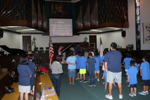 The children and adults pledge to the Bible at the first day of Vacation Bible School on July 30, 2017. 
