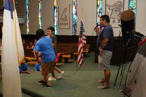 David Flores watches while the last boys play to see who wins the award on the last day of Vacation Bible School on 3 August, 2017. 