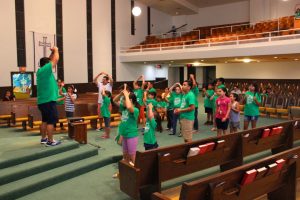 Children participate in fun activities in front of the pulpit at  Vacation Bible School on July 29, 2015. 