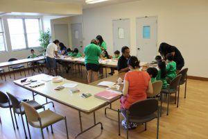Parents help the children create artwork at Vacation Bible School on July 29, 2015.