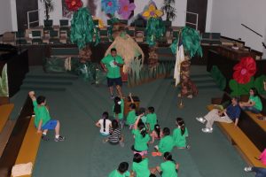 David Flores speaks to the children from the pulpit at Vacation Bible School on July 30, 2015.