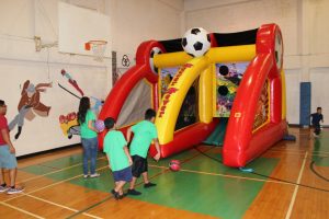 Children play “Soccer Fever” on an inflatable game at Vacation Bible School on July 30, 2015. 