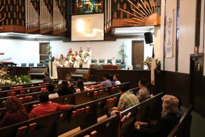 The congregation listens to the choir sing during the Spanish language service on Easter Sunday, April 16, 2017.